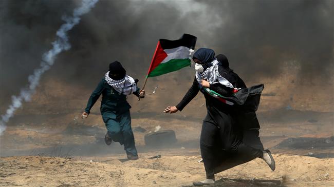 Female demonstrators run for cover from tear gas fired by Israeli forces during a protest where Palestinians demand the right to return to their homeland, along the border between the besieged Gaza Strip and occupied territories in the southern Gaza Strip, May 11, 2018. (Photo by Reuters)
