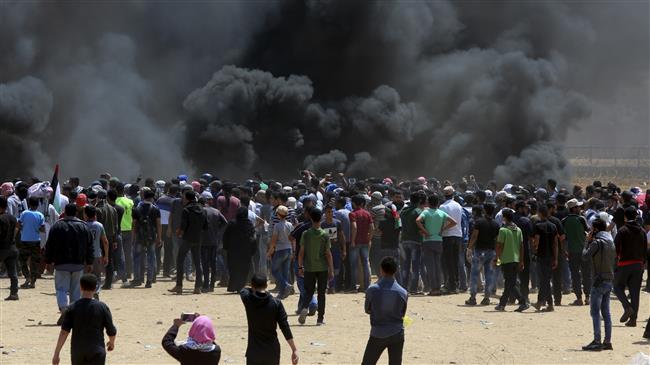 Palestinians carry national flags as they stage a rally to mark the 69th anniversary of 