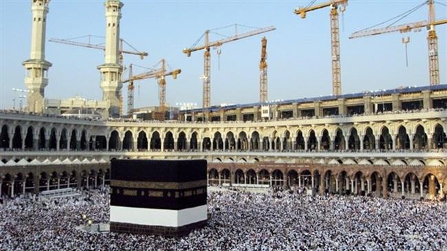 This photo shows cranes in the background at construction sites behind Mecca