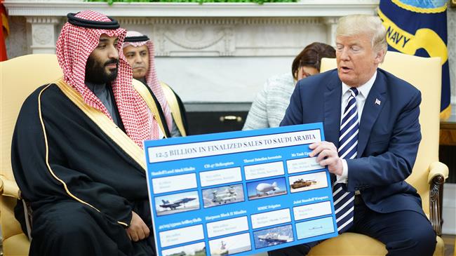 US President Donald Trump (R) holds a military sales chart with Saudi Arabia