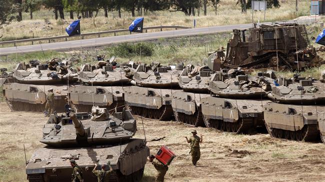 Israeli soldiers walk by Merkava Mark IV tanks during a military drill in the Israeli-annexed Golan Heights on May 1, 2018. (Photo by AFP)
