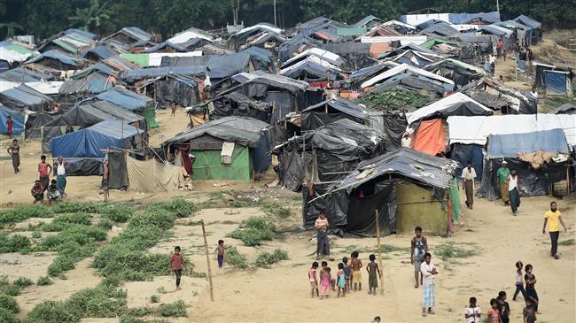 Rohingya Muslim refugees gather near their shelters in the 