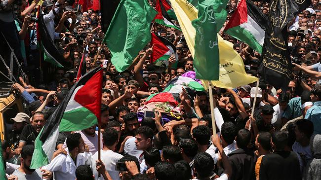 Thousands attend funeral of Palestinian nurse shot dead in anti-Israel rally
