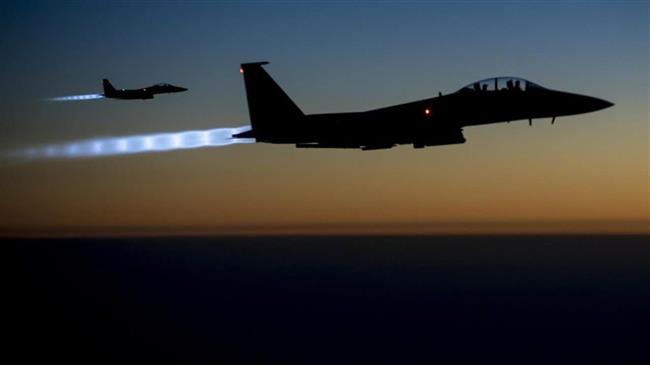 In this file picture, a pair of US Air Force F-15E Strike Eagles flies over northern Iraq after conducting airstrikes in Syria. (Photo by US Air Force)
