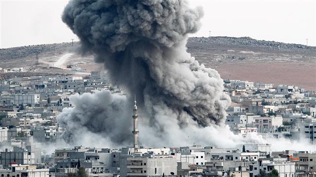 In this file photo, heavy smoke rises from Kobani, Syria, following an airstrike by the US-led coalition there. (Photo by Getty Images)