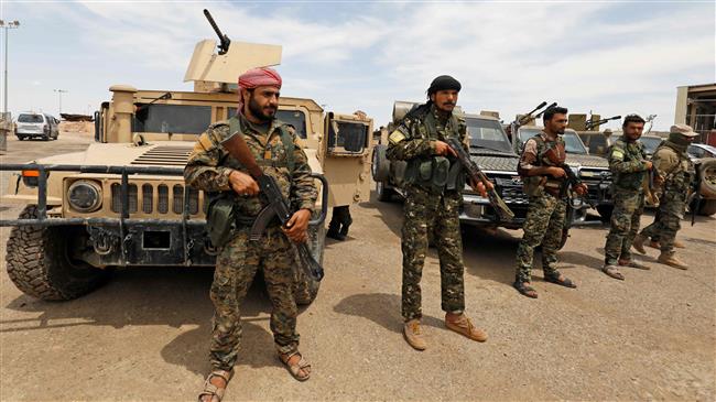 Members of the so-called Syrian Democratic Forces (SDF) gather at the al-Tanak oil field as they prepare for a military campaign near the city of al-Bukamal, Dayr al-Zawr Province, eastern Syria, on May 1, 2018. (Photo by AFP)
