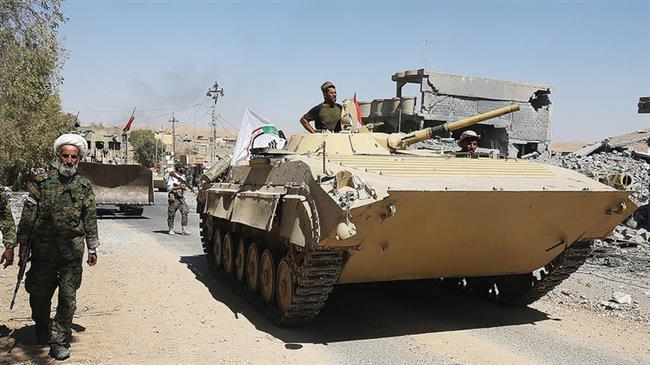 Armored vehicles and bulldozers of the Hashed Al-Shaabi (Popular Mobilization units) advance through the town of Tal Afar, west of Mosul, Iraq on August 26, 2017. (Photo by AFP)
