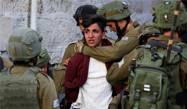 Israeli soldiers arrest a young Palestinian boy