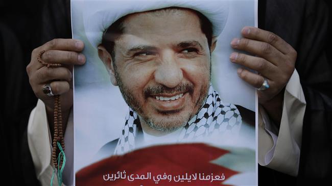 A Bahraini anti-government protester holds up an image of detained Bahraini opposition leader Sheikh Ali Salman during a protest in Daih, Bahrain on February 25, 2015. (Photo by AP)
