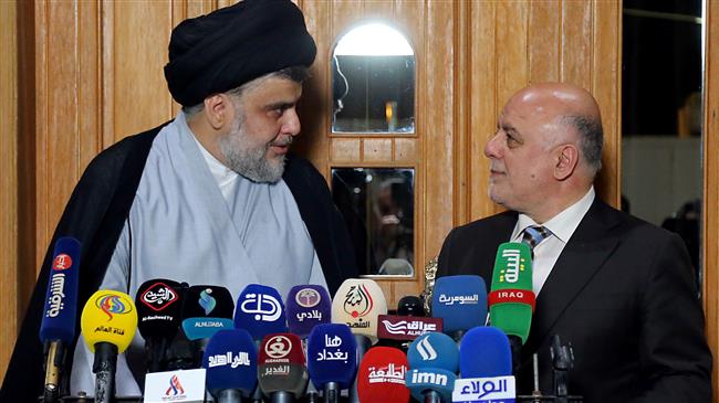 Iraqi Prime Minister Haider al-Abadi (R) attend a press conference with Iraqi cleric and leader Moqtada al-Sadr in Najaf on June 23, 2018. (Photo by AFP)
