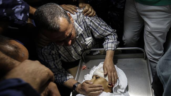 The father of Yasser Abu al-Naja, a Palestinian teenager who was killed in border clashes near Khan Yunis, reacts at a hospital morgue in the Gaza Strip on June 29, 2018. (Photo by AFP)
