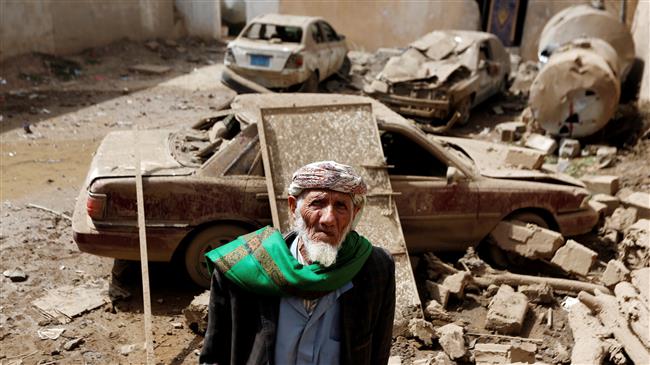A man stands next to cars damaged by a Saudi airstrike in Amran, Yemen, on June 25, 2018. (Photo by Reuters)
