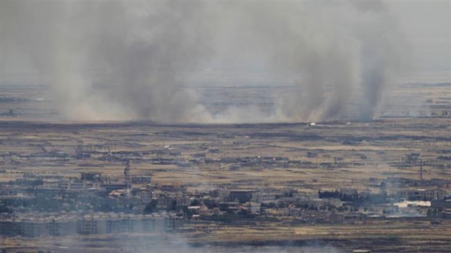 A picture taken from the Israeli-occupied Golan Heights shows smoke billowing from the Syrian side of the border on June 26, 2017. (Photo by AFP)

