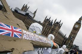 Amnesty International activists march with homemade replica missiles bearing the message 