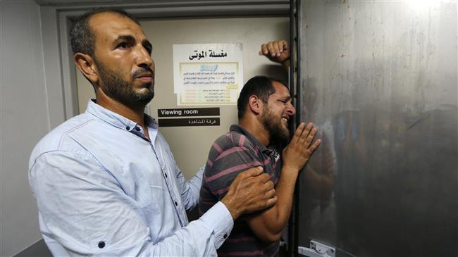 A relative of a Palestinian who was killed by Israeli troops east of Khan Younis reacts at a hospital in the central Gaza Strip on July 20, 2018. (Photo by Reuters)
