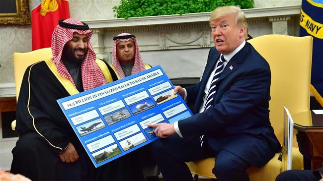 President Donald Trump holds up a chart of military hardware sales as he meets with Crown Prince Mohammed bin Salman of Saudi Arabia in the Oval Office at the White House, March 20, 2018. (Photo by EFE)
