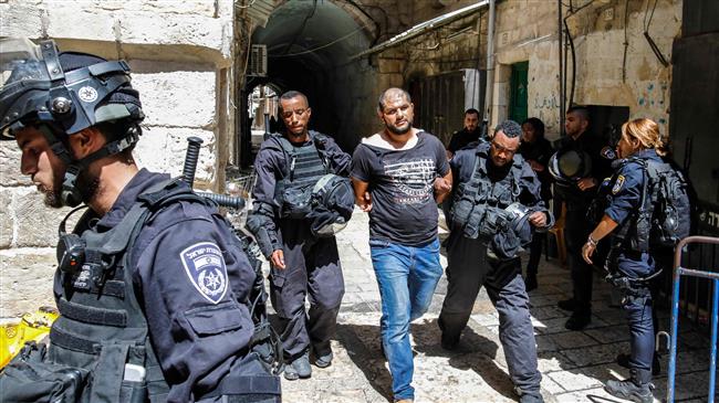 Israeli forces take into custody a Palestinian protester, who was arrested during clashes at the Aqsa Mosque compound in the Old City of Jerusalem al-Quds on July 27, 2018. (Photo by AFP)
