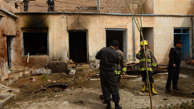 Firefighters and members of security forces inspect the site of a bomb attack at a Shia mosque in Herat, Afghanistan, March 25, 2018. (AFP)
