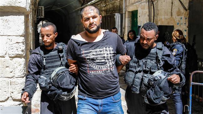 Israeli forces arrest a Palestinian protester during clashes at the al-Aqsa Mosque compound in the occupied Old City of Jerusalem al-Quds on July 27, 2018. (Photo by AFP)
