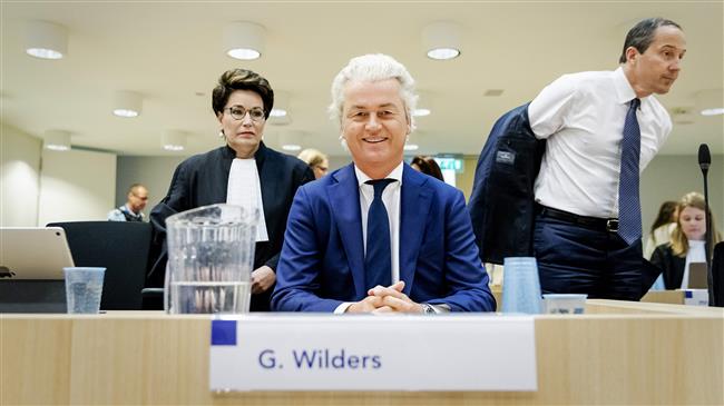 Leader of Dutch far-right Freedom Party (PPV) Geert Wilders (C) sits between his lawyers Carry Knoops-Hamburger (L) and Geert-Jan Knoops at the beginning of the appeal in the hate speech trial in the high security court at Schiphol, the Netherlands, on May 17, 2018. (Photo by AFP)
