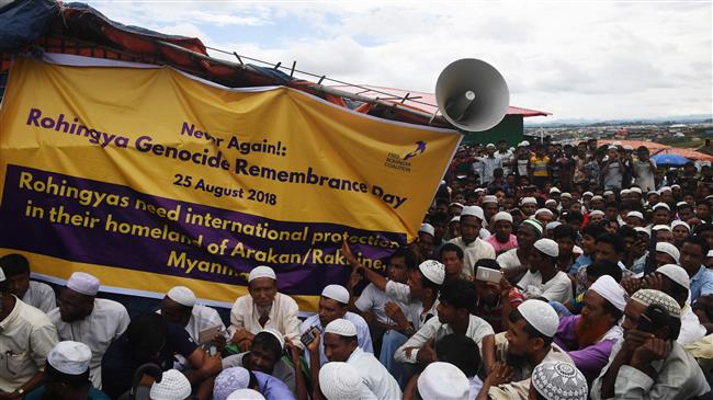 Rohingya refugees attend a ceremony organized to remember the first anniversary of a military crackdown that prompted a massive exodus of people from Myanmar to Bangladesh, at the Kutupalong refugee camp in Ukhia on August 25, 2018. (Photo by AFP)
