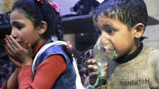 In this file picture, a Syrian child coughs while another puts an oxygen mask over his face following an alleged chemical attack in Douma city, located about 10 kilometers northeast of the center of Damascus. (Photo by the AP)
