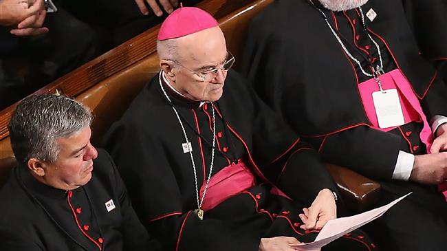 Archbishop Carlo Maria Vigano (C) sits among the Catholic clergy and members of Congress as Pope Francis addresses a joint meeting of the US Congress in the House Chamber of the US Capitol in Washington, September 24, 2015.
