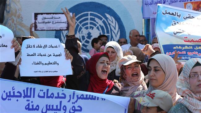 United Nations Relief and Works Agency (UNRWA) staff take part in a protest in front of the agency