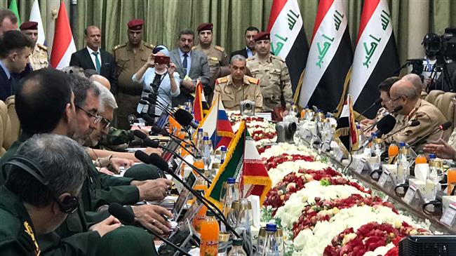 This handout picture released by the official Syrian state television on September 1, 2018 shows Iraqi military commanders (C) seated during a security cooperation and information-sharing meeting with their Iranian, Syrian and Russian counterparts in the Iraqi capital, Baghdad. (Via AFP)
