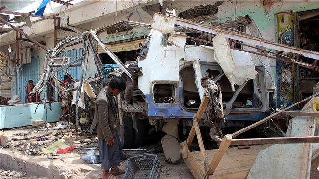 In this file photo taken on August 10, 2018, a Yemeni child stands next to the destroyed bus at the site of a Saudi airstrike, that targeted the Dhahyan market the previous day in the province of Sa