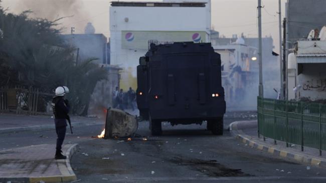 Anti-regime Bahraini protesters clash with riot police firing tear gas after the funeral of an 18-year-old youth in the village of Shahrakan, on April 5, 2016. (Photo by AFP)
