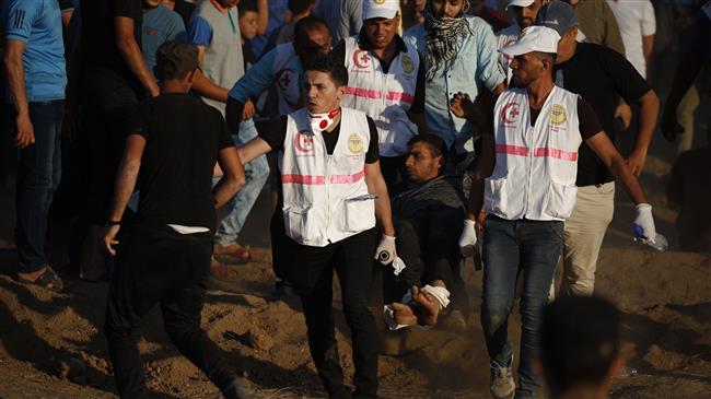 Paramedics carry a wounded Palestinian protester during a demonstration at the fence separating the besieged Gaza Strip from the occupied territories, east of Gaza City on September 14, 2018. (Photo by AFP)
