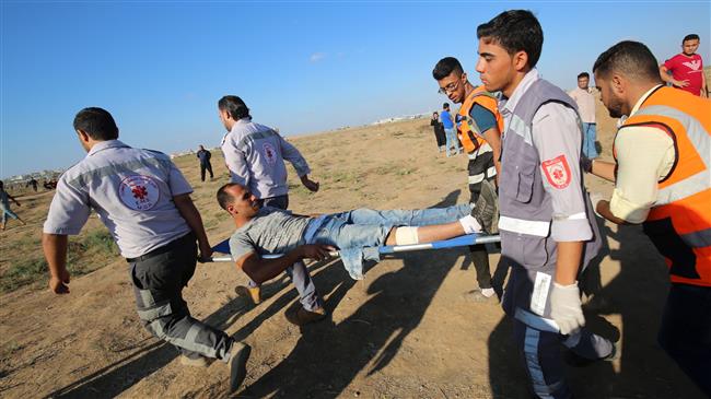 Palestinian paramedics carry an injured protester during a demonstration along the border fence between the Gaza Strip and Israeli-occupied territories east of Gaza City on September 14, 2018. (Photo by AFP)
