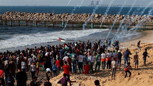 People in northern part of the besieged Gaza Strip are holding a rally in protest against the decade-long siege on the impoverished sliver as Israeli troops are showering them with tear gas canisters, on September 24, 2018.
