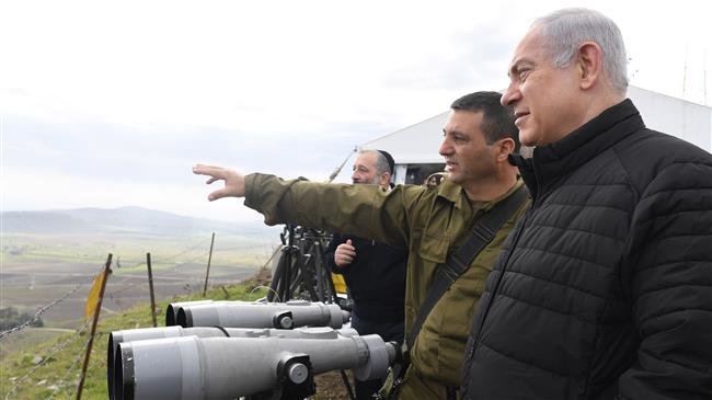 Israeli Prime Minister Benjamin Netanyahu (R) seen in this handout photo during a visit to the Golan Heights in February 2016.
