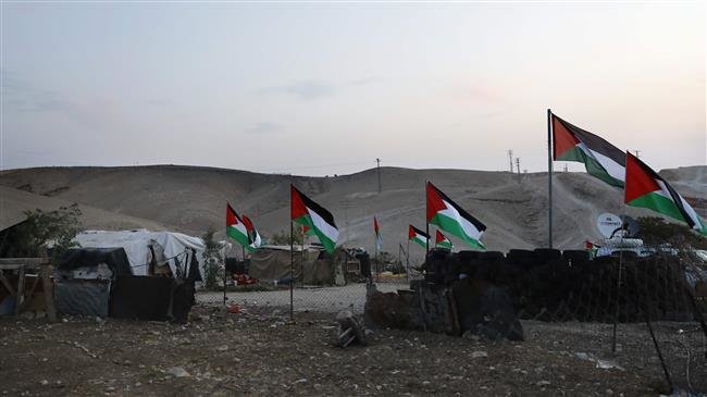 Palestinian Bedouin village of Khan al-Ahmar, east of occupied Jerusalem al-Quds, is seen decorated with Palestinian flags by activists and residents of the village, October 2, 2018. (Photo by AFP)
