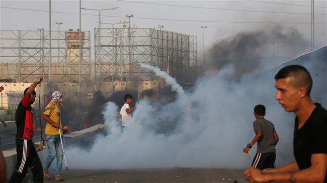 Palestinian protesters demonstrate in tear gas smokes at the Erez crossing in the northern Gaza Strip on October 3, 2018. (Photo by AFP)
