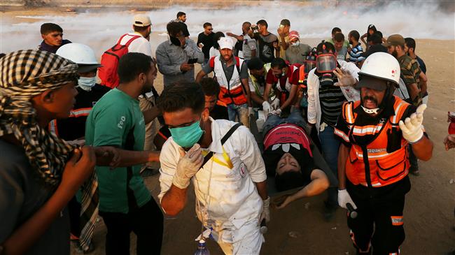A wounded Palestinian is evacuated during a protest calling for lifting the Israeli blockade on Gaza and demanding the right to return to their homeland, at the border fence between the besieged Gaza Strip and Israeli-occupied territories on October 5, 2018. (Photo by Reuters)

