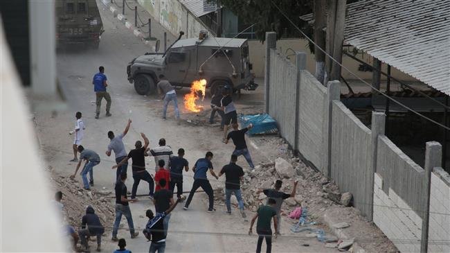 Protesters throw stones and Molotov cocktails at Israeli forces in the village of Shuwaykah in the occupied West Bank on October 7, 2018. (Photo by AFP)
