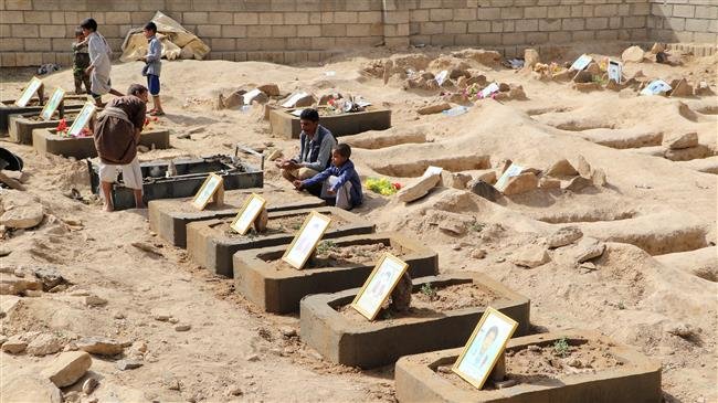 Abdullah al-Khawlani sits by his son Waleed