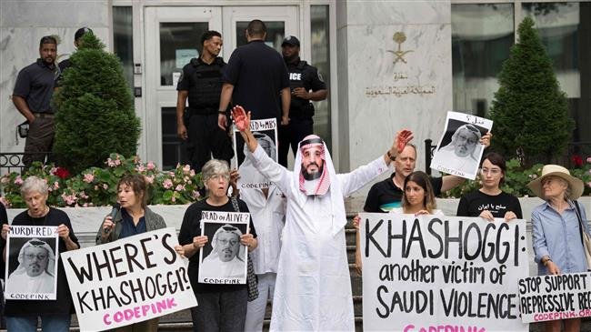A demonstrator dressed as Saudi Crown Prince Mohammed bin Salman (C) with blood on his hands protests outside the Saudi embassy in Washington on October 8, 2018, demanding justice for missing Saudi journalist Jamal Khashoggi. (Photo by AFP)
