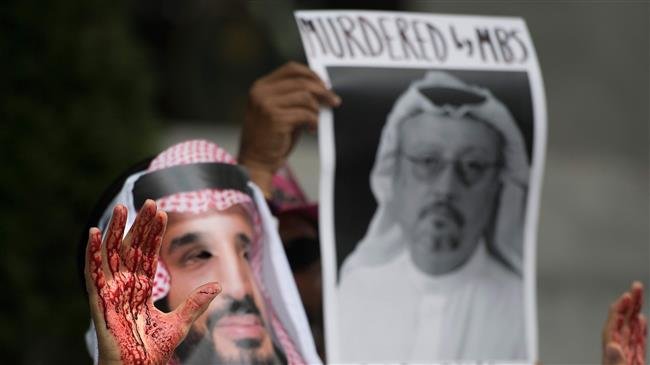 A demonstrator dressed as Saudi Arabia Crown Prince Mohammed bin Salman with blood on his hands protests outside the Saudi Embassy in Washington, DC, on October 8, 2018, demanding justice for missing Saudi journalist Jamal Khashoggi. (Photo by AFP)

