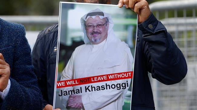 A demonstrator holds picture of Saudi journalist Jamal Khashoggi during a protest in front of Saudi Arabia