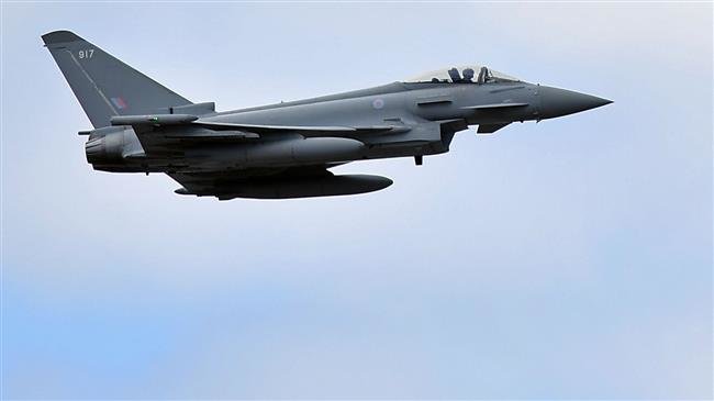 A British Royal Air Force (RAF) Eurofighter Typhoon aircraft perform a fly-past during the Farnborough Airshow, south west of London, on July 17, 2018. (Photo by AFP)
