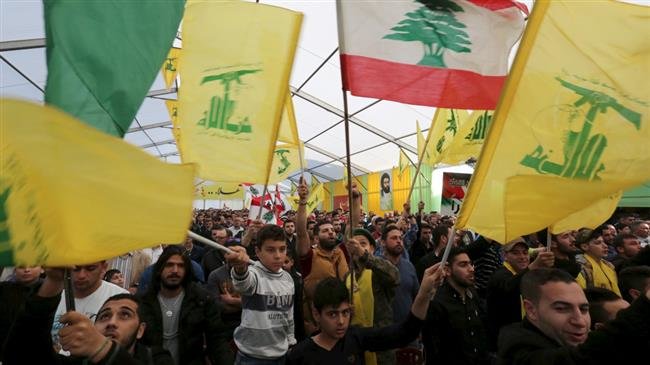 Supporters of Lebanon’s Hezbollah wave Hezbollah and Lebanese flags in Ansar village, southern Lebanon, on March 6, 2016. (Photo by Reuters)
