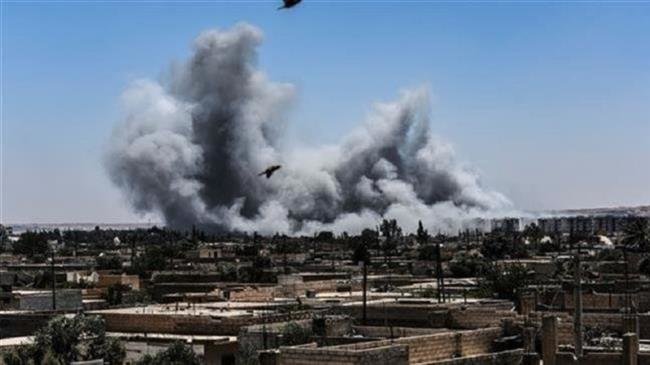 This file photo shows smoke rising after an airstrike by the so-called US-led coalition on the western frontline of the city of Raqqah in Syria on July 15, 2017. (Photo by AFP)