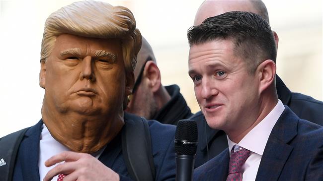 Stephen Yaxley-Lennon (R), AKA Tommy Robinson, founder and former leader of the anti-Islam English Defence League (EDL), addresses supporters, one wearing a mask of US President Donald Trump (L), outside the Old Bailey, London