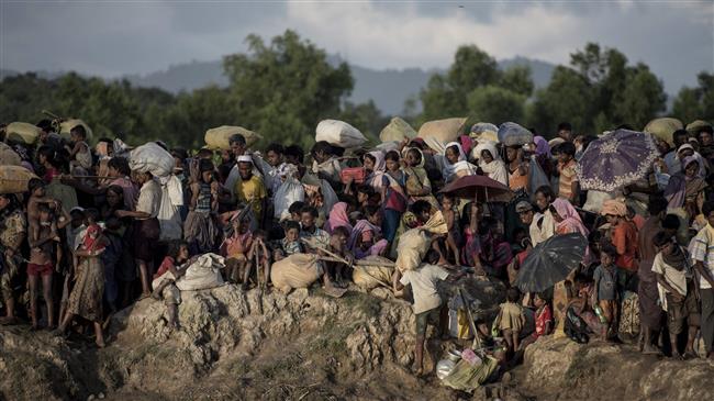This AFP photo taken on October 10, 2017 shows Rohingya refugees fleeing from Myanmar arrive at the Naf river in Whaikyang, Bangladesh border.
