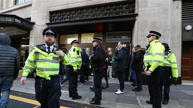 Police officers are seen outside the office building housing Sony Music