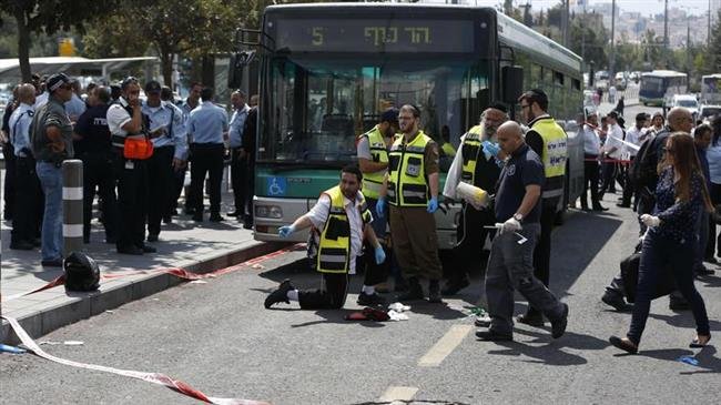 In this file picture, Israeli forces and forensic police inspect the site of an alleged stabbing attack in the occupied city of Jerusalem al-Quds. (Photo by AFP)
